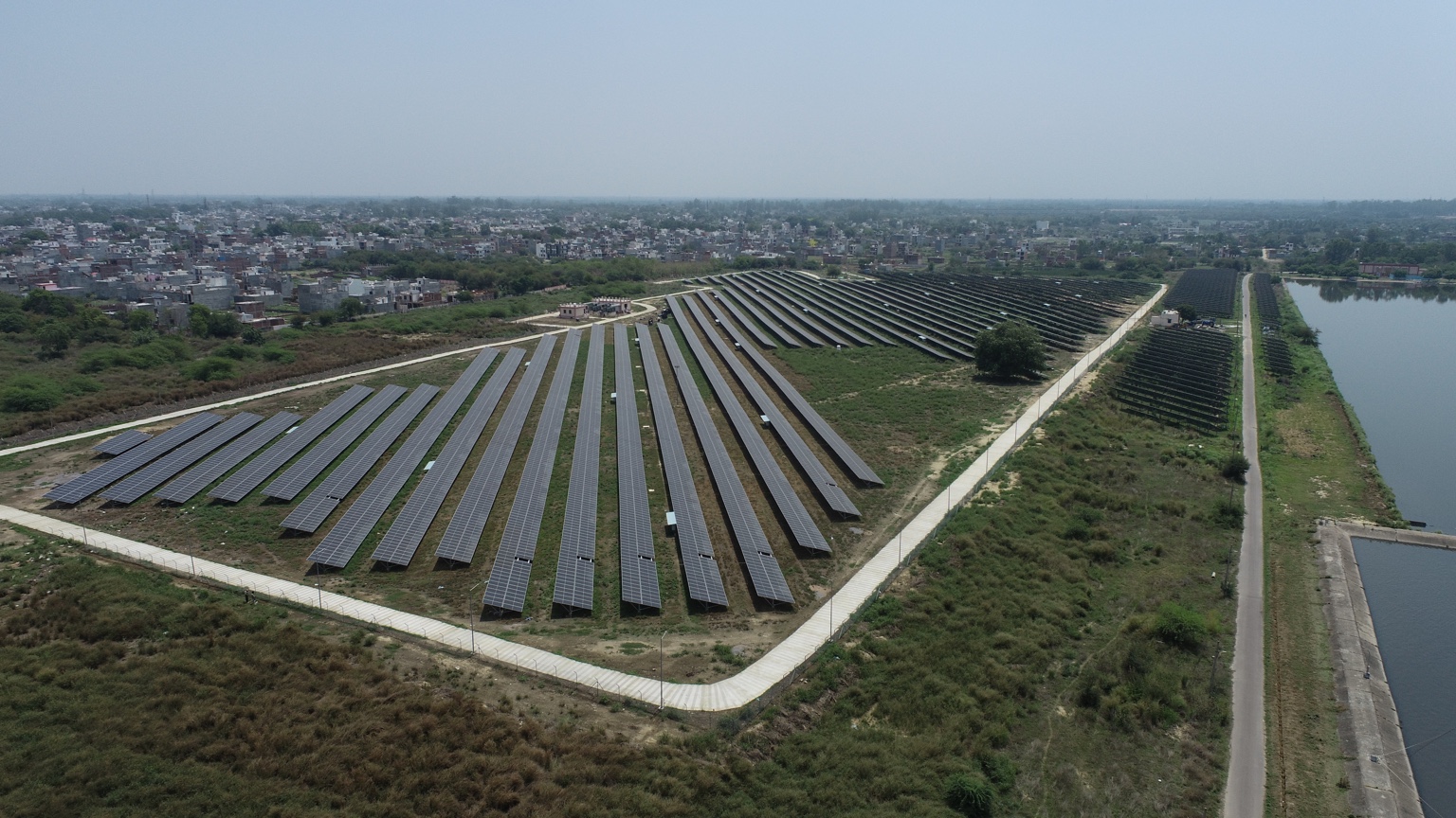 Aerial photograph of solar panels beside water infrastructure
